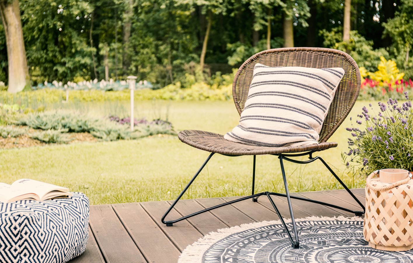 Blick in Garten über die Holzterrasse und den Stuhl